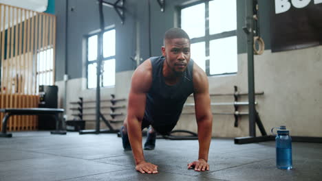man doing push-ups in a gym