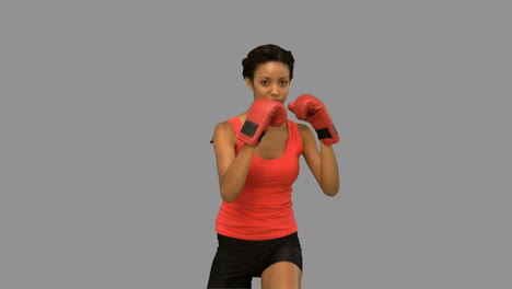 woman boxing on grey screen