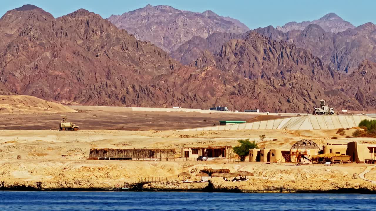 Desert shoreline and red mountains in Sharm El-Sheikh, Egypt under sun