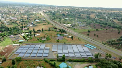 flying low over solar panels on farm in rural africa