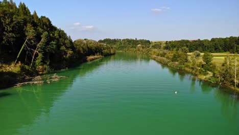 Slow-and-cinematic-shot-over-a-green-river-in-Switzerland