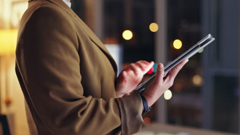 business professional using tablet at night