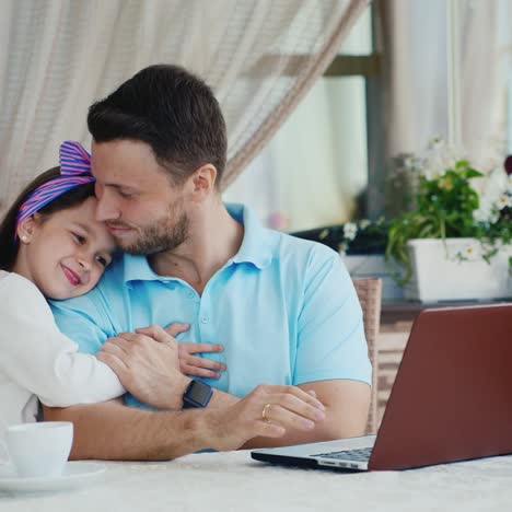 Daughter-Approaches-Father-Using-Laptop