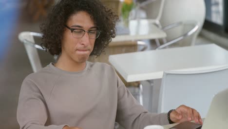 Man-talking-on-mobile-phone-while-using-laptop-4k