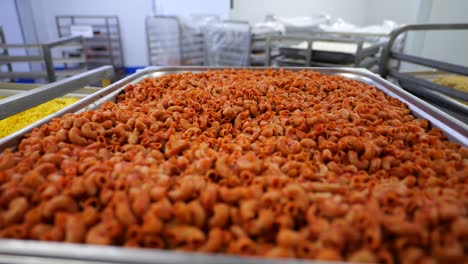 Large-pile-of-pasta-on-food-service-cart-in-commercial-kitchen