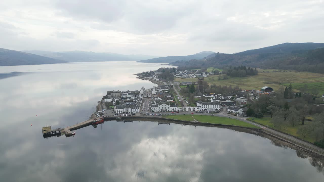 Sweeping Aerial Shot of Inveraray Village Mirroring Peaceful Skies