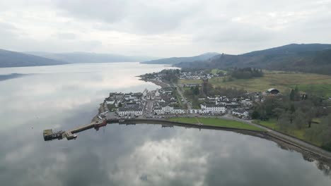 sweeping aerial shot of inveraray village mirroring peaceful skies