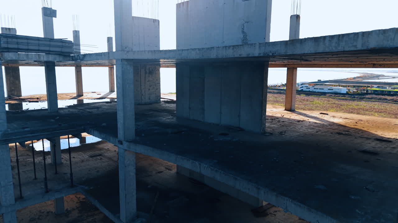 Going down inside the concrete frame of the building under construction. New multi-storied hotel creation at the sea shore