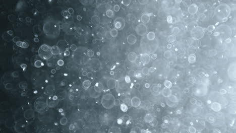 Floating-abstract-particle-bokeh-on-dark-background