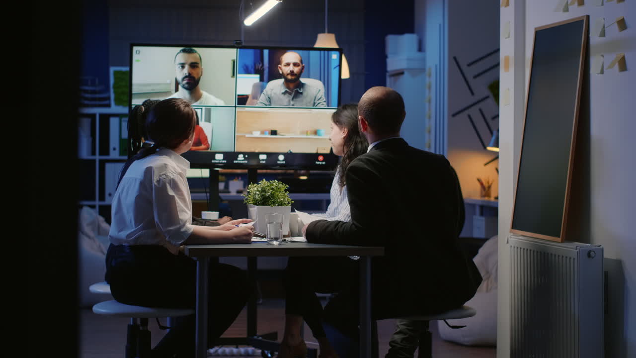 Diverse group of business teamwork discussing with remote coworkers during online videocall