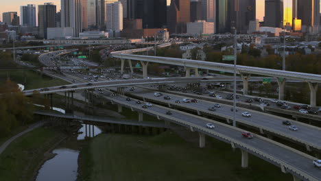 aerial shot of cars on i-45 north freeway and reveal of downtown houston, texas