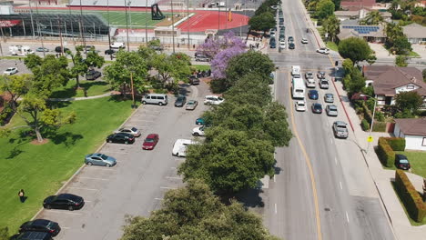 drone footage of the community during the summer. school getting out, parents getting home, people enjoying the community center