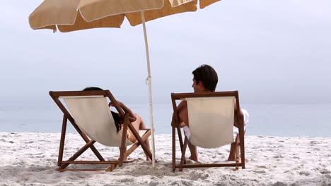 couple under parasol spending time together