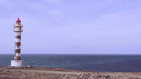 Static-slow-motion---Lighthouse-in-front-of-the-sea-in-a-sunny-day