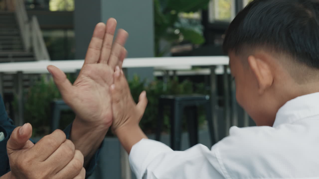 People celebrating with a high five