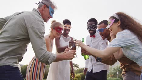 portrait of happy african american married couple with diverse friends drinking beer