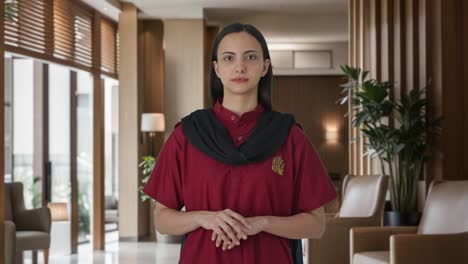 indian female housekeeper looking at the camera