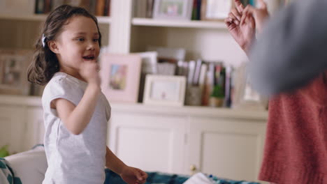 niña linda bailando con la madre en casa familia divirtiéndose padres jugando con el niño en casa el fin de semana
