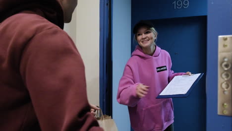 Delivery-woman-with-paper-bags-and-a-clipboard