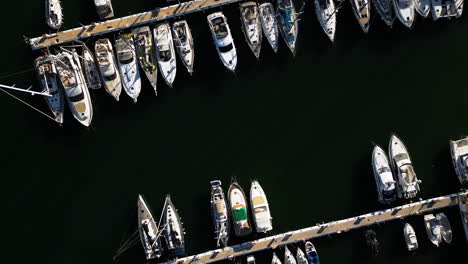 private yachts moored in local pier of estepona, aerial top down view