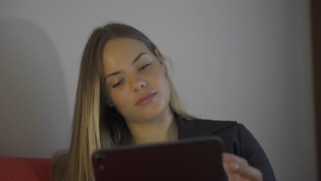 A-young-woman-uses-a-digital-table-in-her-apartment