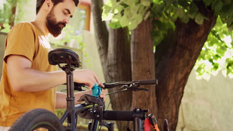 man clamps bicycle frame to repair-stand