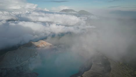 ijen volcano complex group of composite volcanoes with large white clouds, aerial