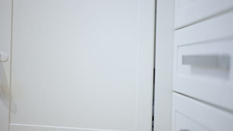 baby exploring a kitchen cabinet