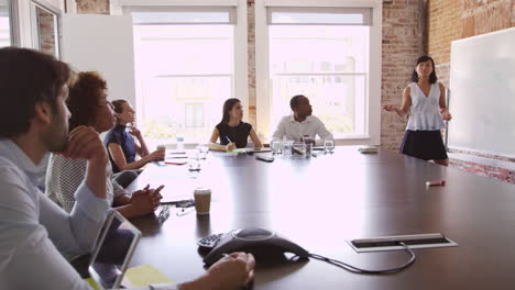 Businesswoman-At-Whiteboard-Giving-Presentation-Shot-On-R3D