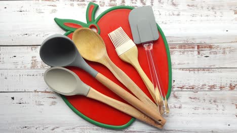 assorted kitchen utensils on a cutting board