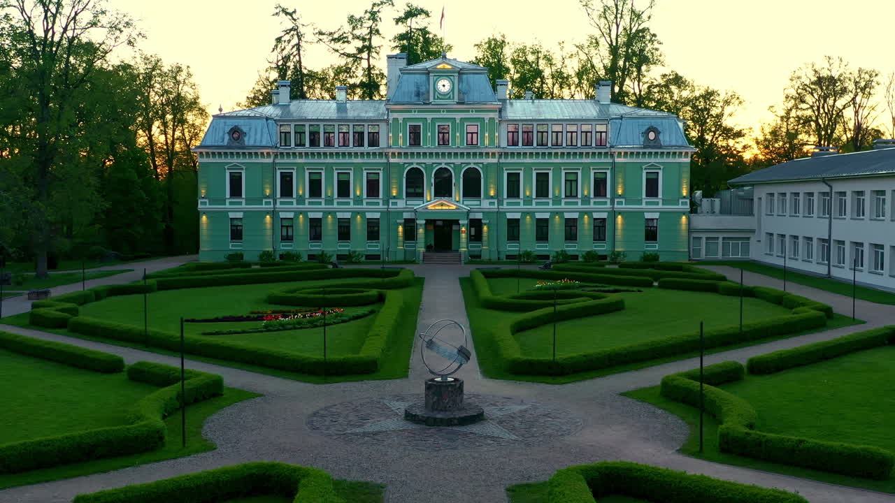 Historic Kokmuiža Manor in Latvia With Formal Garden During Golden Hour Light