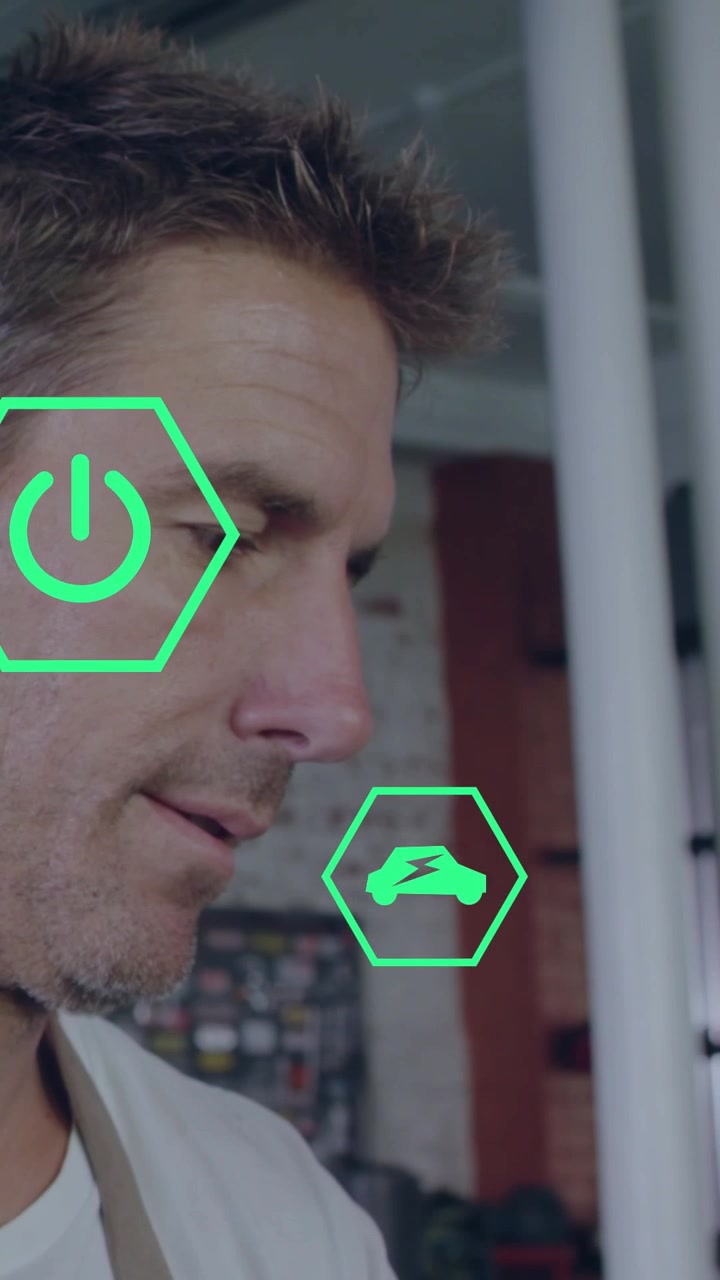 Vertical video: Tech tilting tablet tapping screen in shop animating green icons analyzing energy