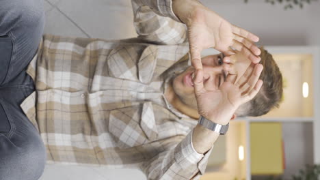 Vertical-video-of-Man-making-heart-symbol-for-camera.