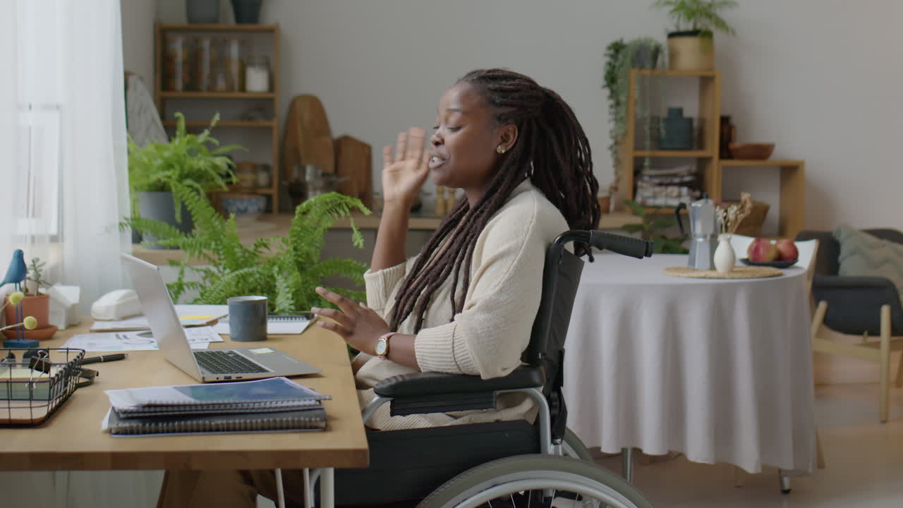 Black Woman in Wheelchair Web Conferencing at Home