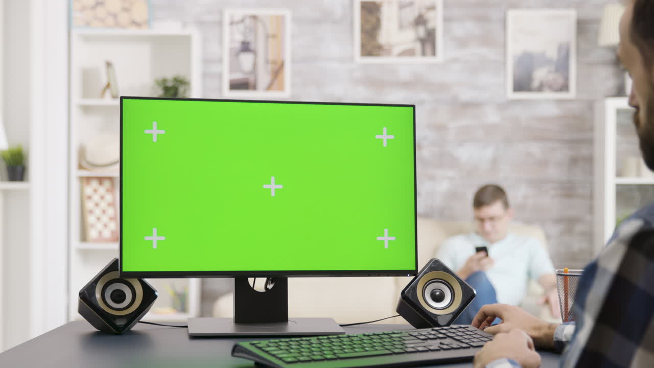 Computer monitor with green screen in a home office setting