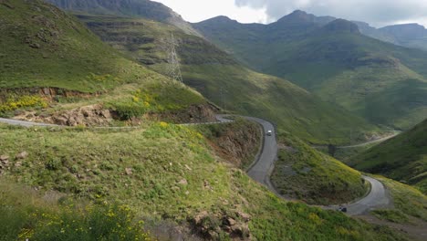 vehicles drive up twisty moteng pass in northern mountains of lesotho