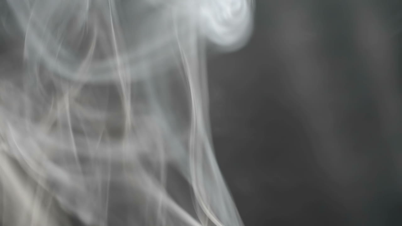 Slow motion. Smoke and background. Gray smoke on a black background