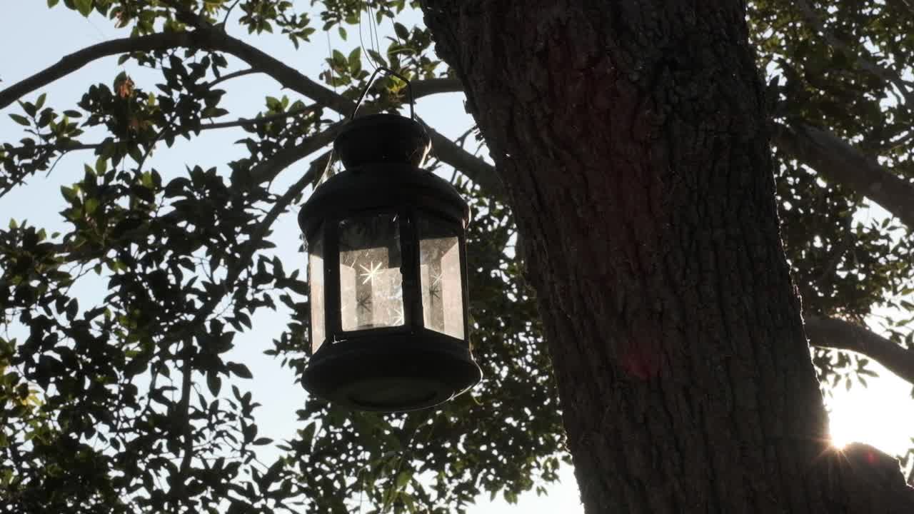 Colourful light rays play around a hanging glass lantern