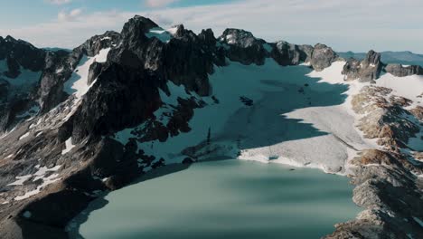 lagoon of glaciar ojo del albino trek with rocky mountains near ushuaia, argentina