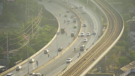 aerial view of cars driving on highway street road at bangkok downtown skyline, thailand. financial district and business centers in urban city in asia.