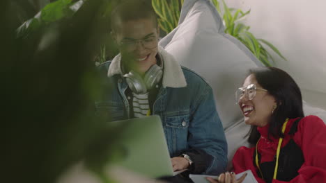 young-group-of-business-people-students-working-together-sharing-information-brainstorming-ideas-studying-using-laptop-computer-technology-successful-high-five-in-relaxed-office-workplace