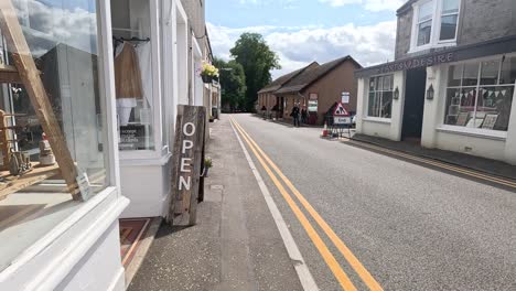 a peaceful street scene with shops and signs