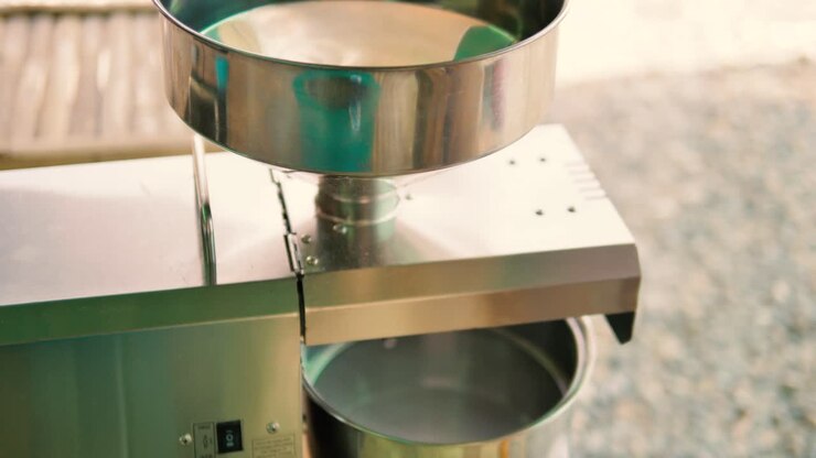 Man pouring seeds into Oil Press. 4k, slomo