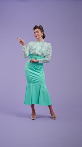 elegant woman in vintage attire pointing on purple background