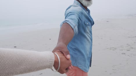 mature couple enjoying time outside by the sea