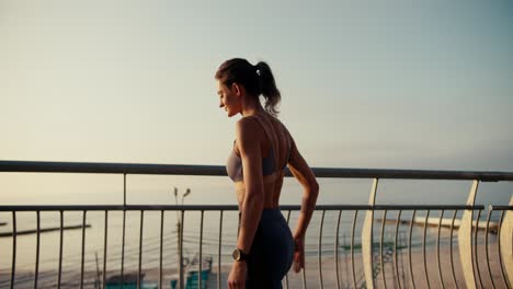 A-girl-with-a-ponytail-in-a-sports-summer-uniform-does-stretching-and-warms-up-before-a-morning-run.-Sports-in-the-morning