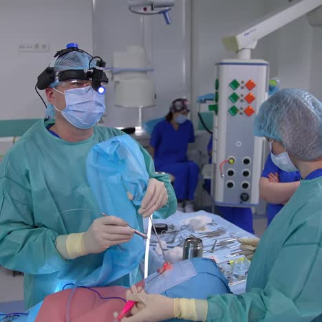 a team of surgeons perform a surgical operation. cooperating team of multi-ethnic surgeous perform organ transplant operation in operating room