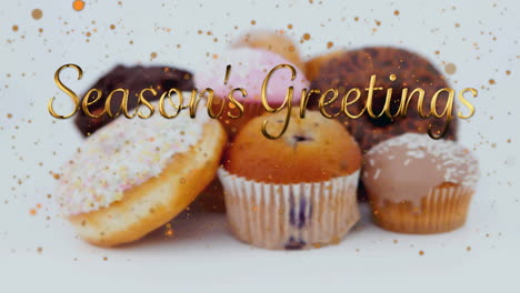 animation of christmas greetings over cupcakes on white background