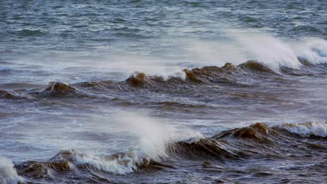 Sea-waves-rolling-in-wind-in-golden-hour-handheld-panning