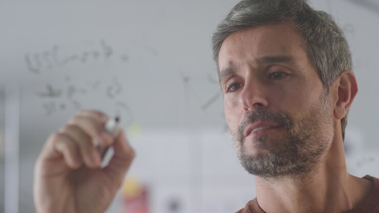 Close Up Of Businessman In Creative Office Brainstorming And Writing Ideas On Transparent Screen